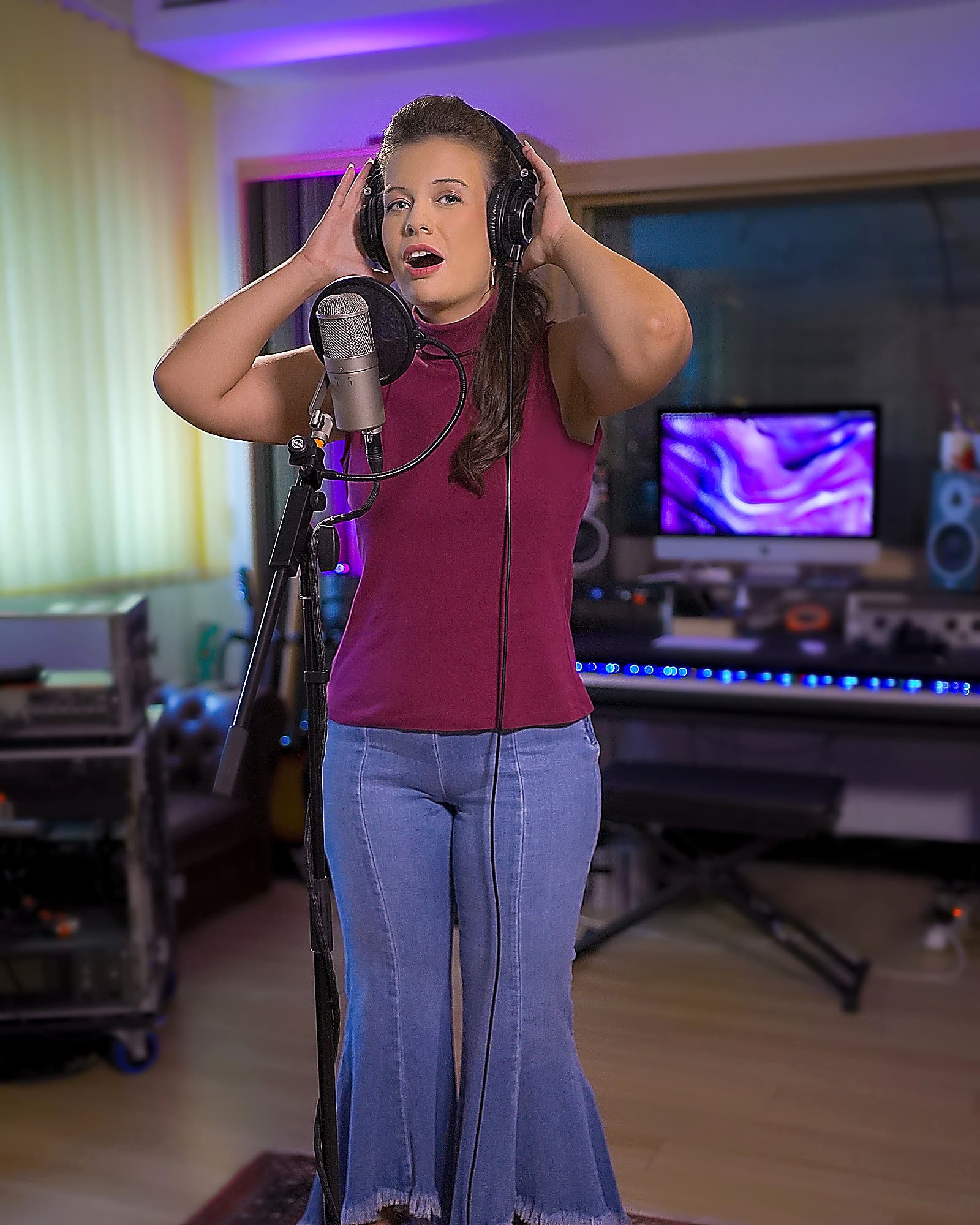 GLORIALLE recording a vocal performance in the studio